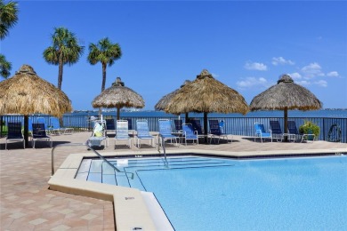 GORGEOUS & nestled on the golf greens with peaceful views, this on Isla Del Sol Yacht and Country Club in Florida - for sale on GolfHomes.com, golf home, golf lot