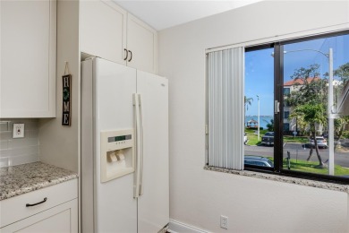 GORGEOUS & nestled on the golf greens with peaceful views, this on Isla Del Sol Yacht and Country Club in Florida - for sale on GolfHomes.com, golf home, golf lot