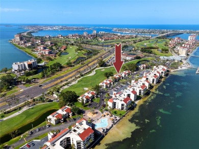 GORGEOUS & nestled on the golf greens with peaceful views, this on Isla Del Sol Yacht and Country Club in Florida - for sale on GolfHomes.com, golf home, golf lot
