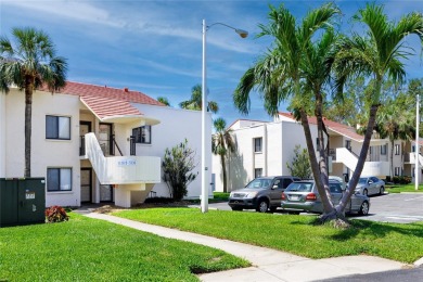 GORGEOUS & nestled on the golf greens with peaceful views, this on Isla Del Sol Yacht and Country Club in Florida - for sale on GolfHomes.com, golf home, golf lot