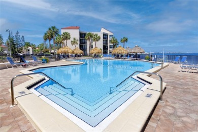 GORGEOUS & nestled on the golf greens with peaceful views, this on Isla Del Sol Yacht and Country Club in Florida - for sale on GolfHomes.com, golf home, golf lot