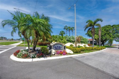GORGEOUS & nestled on the golf greens with peaceful views, this on Isla Del Sol Yacht and Country Club in Florida - for sale on GolfHomes.com, golf home, golf lot