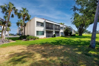 GORGEOUS & nestled on the golf greens with peaceful views, this on Isla Del Sol Yacht and Country Club in Florida - for sale on GolfHomes.com, golf home, golf lot
