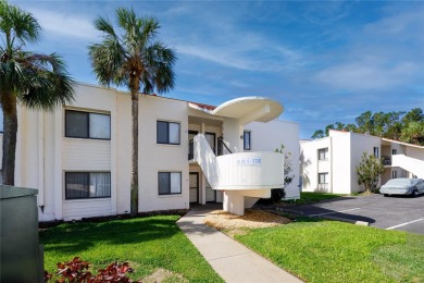 GORGEOUS & nestled on the golf greens with peaceful views, this on Isla Del Sol Yacht and Country Club in Florida - for sale on GolfHomes.com, golf home, golf lot