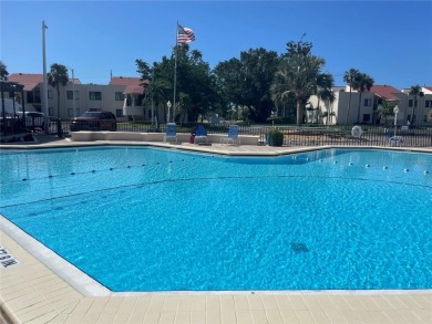GORGEOUS & nestled on the golf greens with peaceful views, this on Isla Del Sol Yacht and Country Club in Florida - for sale on GolfHomes.com, golf home, golf lot
