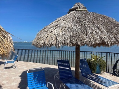 GORGEOUS & nestled on the golf greens with peaceful views, this on Isla Del Sol Yacht and Country Club in Florida - for sale on GolfHomes.com, golf home, golf lot