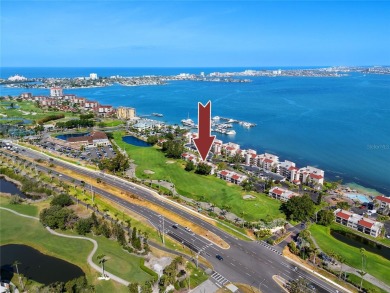 GORGEOUS & nestled on the golf greens with peaceful views, this on Isla Del Sol Yacht and Country Club in Florida - for sale on GolfHomes.com, golf home, golf lot