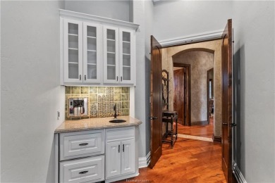 This custom estate sits on a rare 1.4-acre wooded lot backing to on The Traditions Club At Texas A and M in Texas - for sale on GolfHomes.com, golf home, golf lot