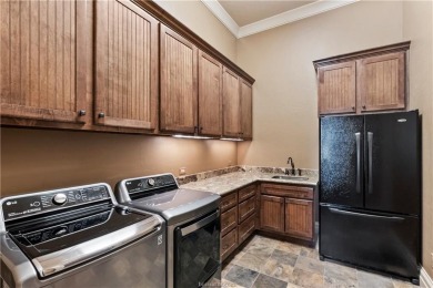 This custom estate sits on a rare 1.4-acre wooded lot backing to on The Traditions Club At Texas A and M in Texas - for sale on GolfHomes.com, golf home, golf lot