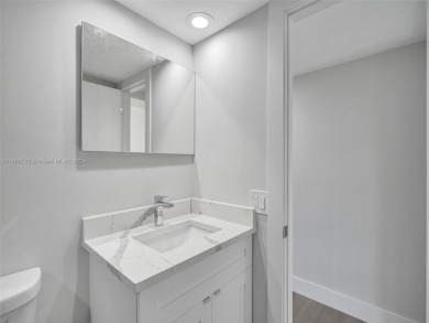 Discover luxurious living in this fully renovated 3-bedroom on Palm-Aire Country Club and Resort - The Oaks in Florida - for sale on GolfHomes.com, golf home, golf lot