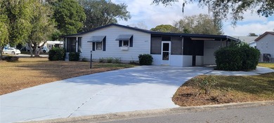 Welcome home to this charming 940 sq. ft., 2-bedroom, 1-bath on Orange Blossom Hills Golf and Country Club in Florida - for sale on GolfHomes.com, golf home, golf lot