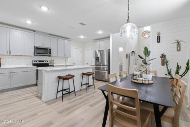 Welcome to 118 Pitching Wedge Drive, a stunning 2023-built home on LPGA International Golf Course in Florida - for sale on GolfHomes.com, golf home, golf lot
