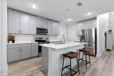 Welcome to 118 Pitching Wedge Drive, a stunning 2023-built home on LPGA International Golf Course in Florida - for sale on GolfHomes.com, golf home, golf lot