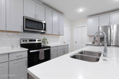 Welcome to 118 Pitching Wedge Drive, a stunning 2023-built home on LPGA International Golf Course in Florida - for sale on GolfHomes.com, golf home, golf lot