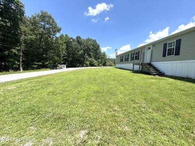 Welcome to your new home! This corner lot manufactured home in on Lake Tansi Village Country Club in Tennessee - for sale on GolfHomes.com, golf home, golf lot