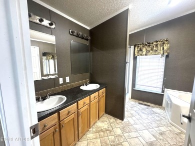 Welcome to your new home! This corner lot manufactured home in on Lake Tansi Village Country Club in Tennessee - for sale on GolfHomes.com, golf home, golf lot