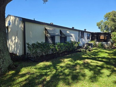 This 2BR/2BA, 896 sq. ft. home is beautifully updated and on Lake Henry Golf Club in Florida - for sale on GolfHomes.com, golf home, golf lot