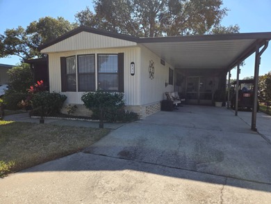 This 2BR/2BA, 896 sq. ft. home is beautifully updated and on Lake Henry Golf Club in Florida - for sale on GolfHomes.com, golf home, golf lot