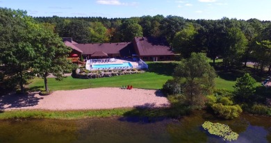 Discover the epitome of convenience and comfort in this on Michaywe Pines Course in Michigan - for sale on GolfHomes.com, golf home, golf lot