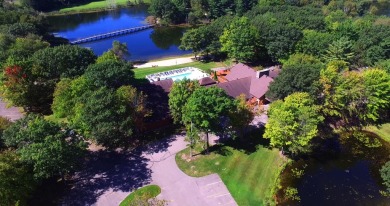 Discover the epitome of convenience and comfort in this on Michaywe Pines Course in Michigan - for sale on GolfHomes.com, golf home, golf lot