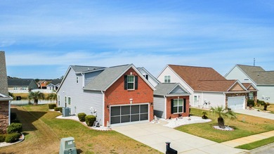 Enjoy stunning views of a serene pond from this beautifully on Palmetto Greens Golf and Country Club in South Carolina - for sale on GolfHomes.com, golf home, golf lot