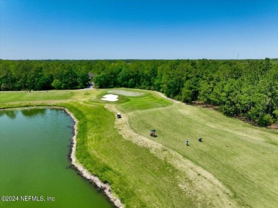 Tranquil Living On The Pond In This Exclusive Gated Golf on Grand Reserve Golf Course in Florida - for sale on GolfHomes.com, golf home, golf lot