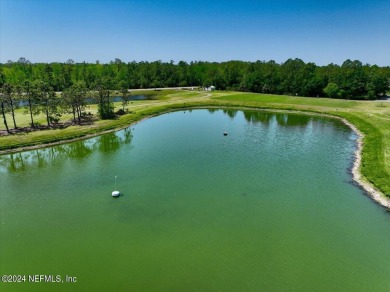 Tranquil Living On The Pond In This Exclusive Gated Golf on Grand Reserve Golf Course in Florida - for sale on GolfHomes.com, golf home, golf lot