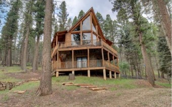 This log home masterpiece shows as beautifully as it lives ! on Angel Fire Resort Country Club in New Mexico - for sale on GolfHomes.com, golf home, golf lot