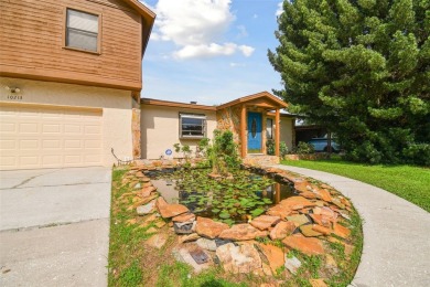 This lovely home in Forest Hills comes with its own fish, flower on Babe Zaharias Golf Course in Florida - for sale on GolfHomes.com, golf home, golf lot