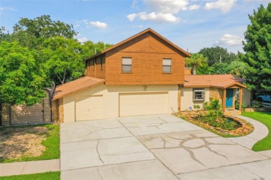 This lovely home in Forest Hills comes with its own fish, flower on Babe Zaharias Golf Course in Florida - for sale on GolfHomes.com, golf home, golf lot