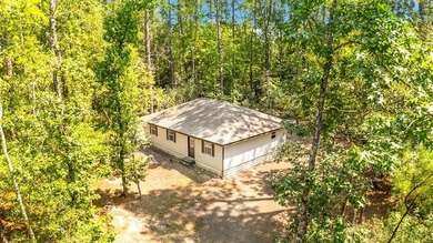 Nestled in the serene embrace of Rayburn Country Resort on Lake on Rayburn Country Club in Texas - for sale on GolfHomes.com, golf home, golf lot