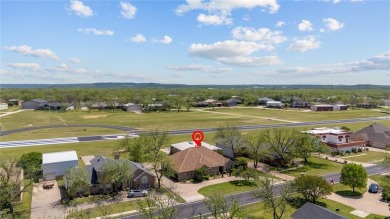 Right off of the airstrip. Discover the perfect blend of luxury on Pecan Plantation Country Club in Texas - for sale on GolfHomes.com, golf home, golf lot