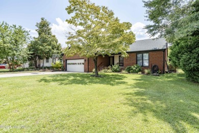 Welcome to 6106 Cutlass Court, a charming brick ranch-style home on Harbour Point Golf Club in North Carolina - for sale on GolfHomes.com, golf home, golf lot