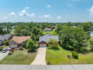 Welcome to 6106 Cutlass Court, a charming brick ranch-style home on Harbour Point Golf Club in North Carolina - for sale on GolfHomes.com, golf home, golf lot