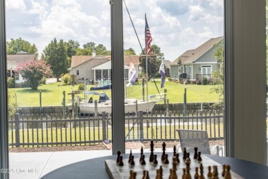 Welcome to 6106 Cutlass Court, a charming brick ranch-style home on Harbour Point Golf Club in North Carolina - for sale on GolfHomes.com, golf home, golf lot