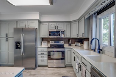 Welcome to 6106 Cutlass Court, a charming brick ranch-style home on Harbour Point Golf Club in North Carolina - for sale on GolfHomes.com, golf home, golf lot
