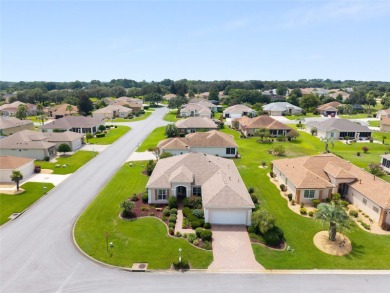 This elegant SANTA ROSA home sits proudly on a corner lot of a on Eagle Ridge At Spruce Creek Country Club in Florida - for sale on GolfHomes.com, golf home, golf lot