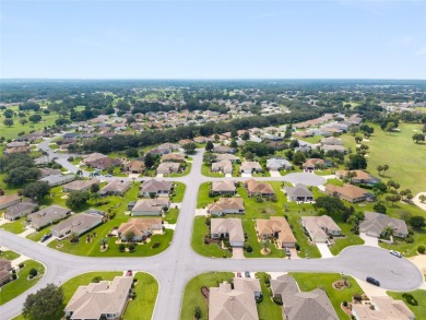 This elegant SANTA ROSA home sits proudly on a corner lot of a on Eagle Ridge At Spruce Creek Country Club in Florida - for sale on GolfHomes.com, golf home, golf lot