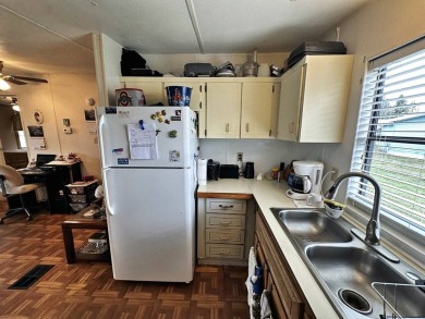 Welcome to your perfect retreat! This cozy 2 bedroom, 1 bathroom on Lake Henry Golf Club in Florida - for sale on GolfHomes.com, golf home, golf lot