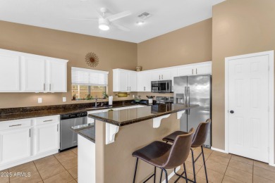 This single level home in The Villages at Queen Creek sits on a on Las Colinas Golf Club in Arizona - for sale on GolfHomes.com, golf home, golf lot