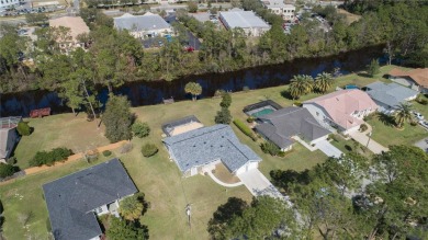 Beautiful, move in a ready canal home in the highly desirable on The Grand Club - Pine Lakes Course in Florida - for sale on GolfHomes.com, golf home, golf lot