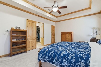 Poised beneath a canopy of mature trees on a gorgeous one-acre on Sugar Tree Golf and Country Club in Texas - for sale on GolfHomes.com, golf home, golf lot