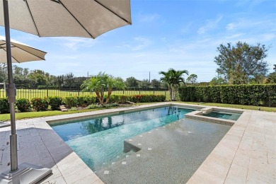 Discover luxury living in this exquisite five-bedroom on Eagle Creek Golf Club in Florida - for sale on GolfHomes.com, golf home, golf lot