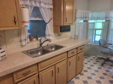 2/2 home has open floor plan. Large eat-in kitchen has lots of on Lake Henry Golf Club in Florida - for sale on GolfHomes.com, golf home, golf lot