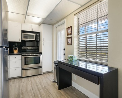 Beautifully remodeled 2BR/2BA top-floor condo in all-age Palm on  in Florida - for sale on GolfHomes.com, golf home, golf lot