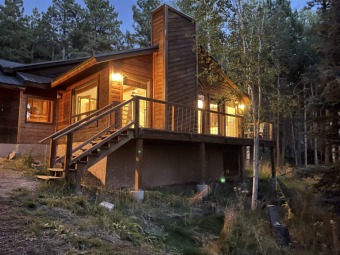Very cool mountain cabin nestled in .77 acres of forested land on Angel Fire Resort Country Club in New Mexico - for sale on GolfHomes.com, golf home, golf lot