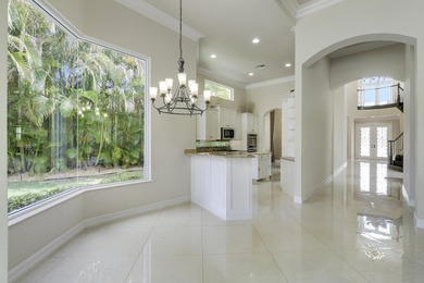 Beautiful home with a waterfront and golf course view! This home on Jupiter Country Club in Florida - for sale on GolfHomes.com, golf home, golf lot