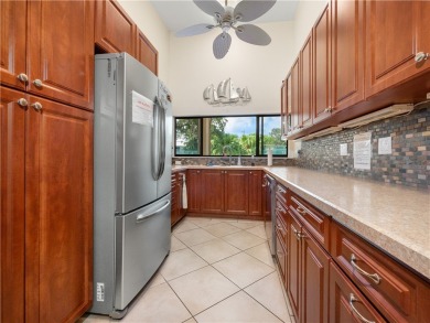 First floor unit with a lake view. 42* kitchen cabinets, granite on Pelican Pointe 9 Hole Course in Florida - for sale on GolfHomes.com, golf home, golf lot