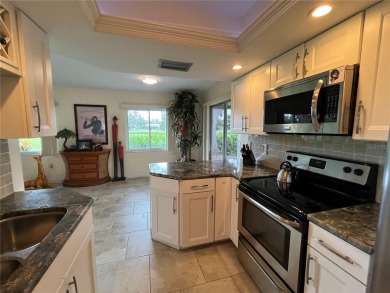 Beautifully Updated GOLF COURSE Frontage Home with the ABSOLUTE on Village Green Golf Club of Sarasota in Florida - for sale on GolfHomes.com, golf home, golf lot