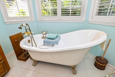 Welcome to this stunning 3-bedroom, 2.5-bathroom waterfront home on Players Course At Wyboo Plantation in South Carolina - for sale on GolfHomes.com, golf home, golf lot